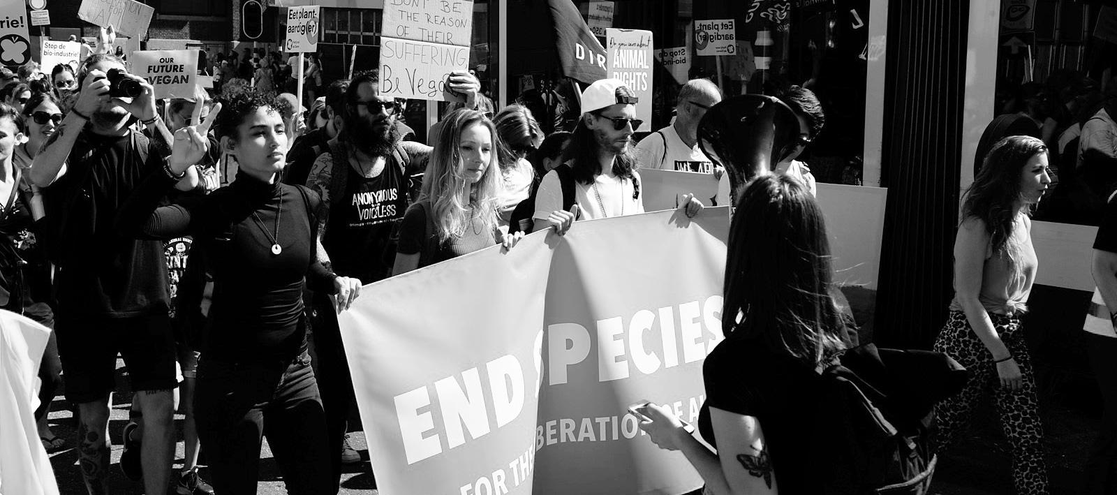 End speciesism march featuring Brenda de Groot holding a banner