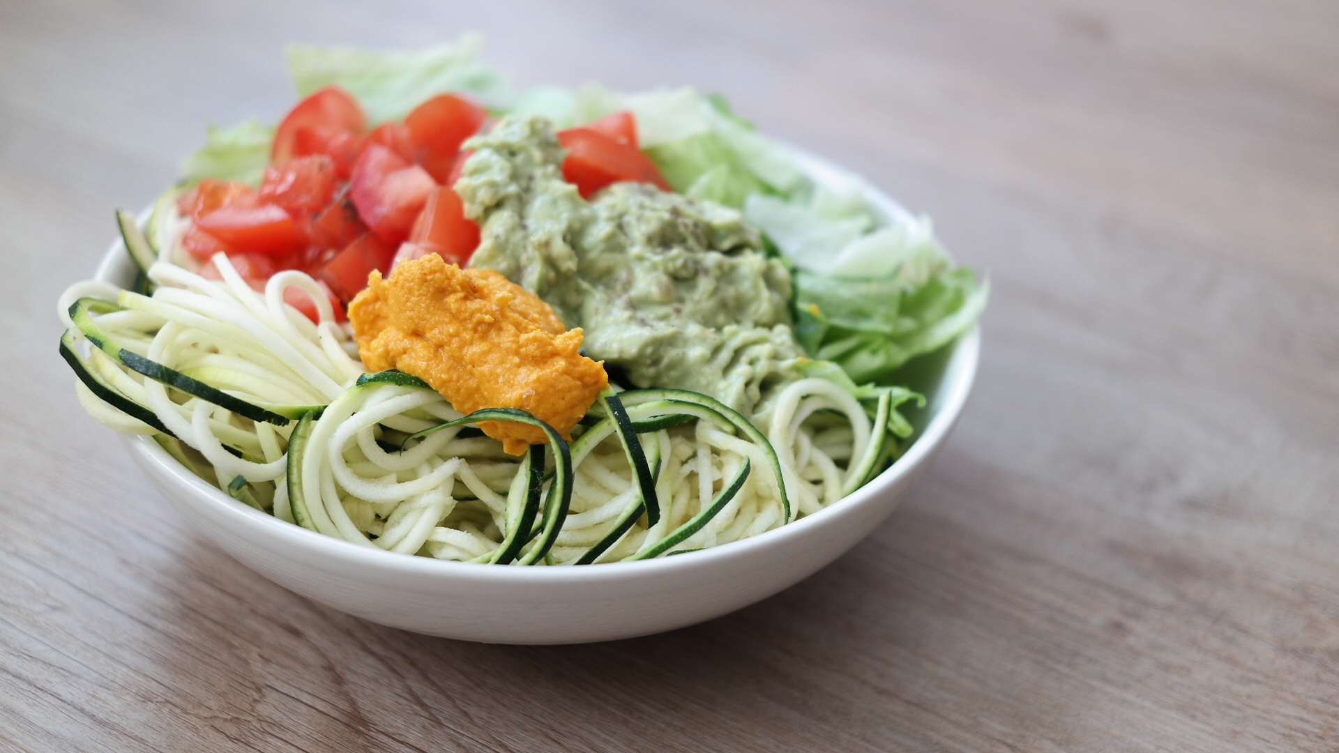 Salade van courgette spaghetti met pompoenhummus en romige avocadosaus